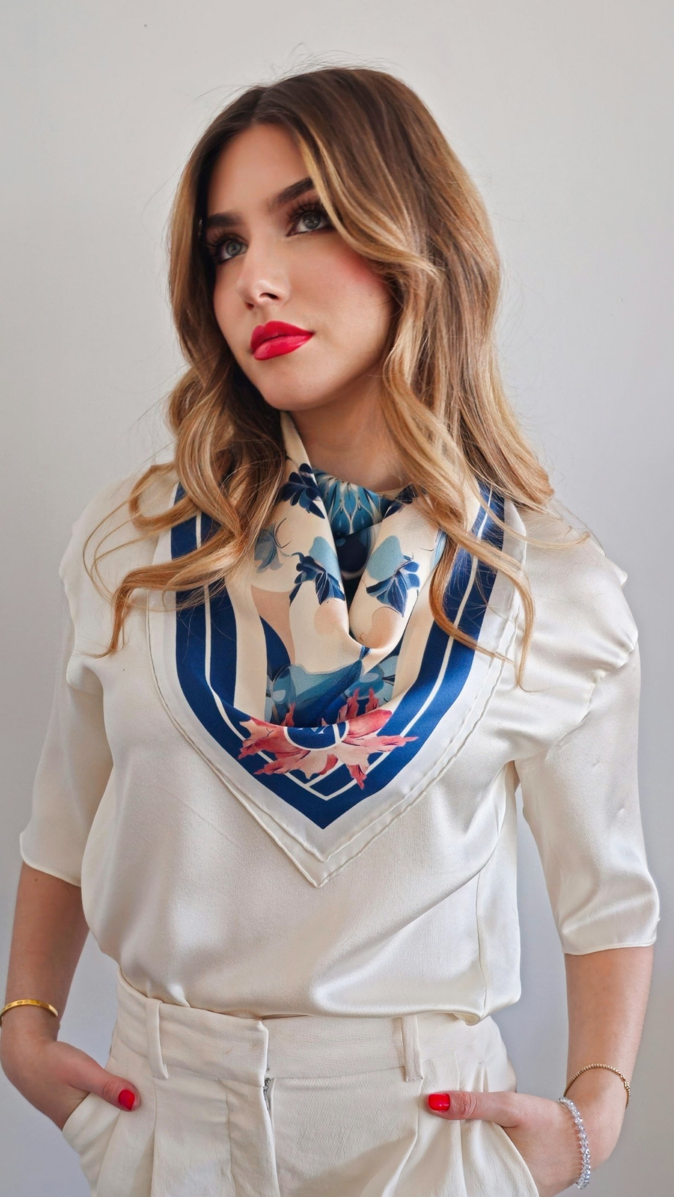 Front view of model in white wearing mazonkiki blue and white scarf