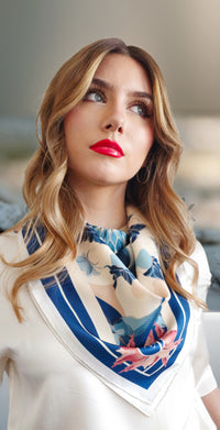 model in white wearing Mazonkiki blue and white silk scarf over neck.