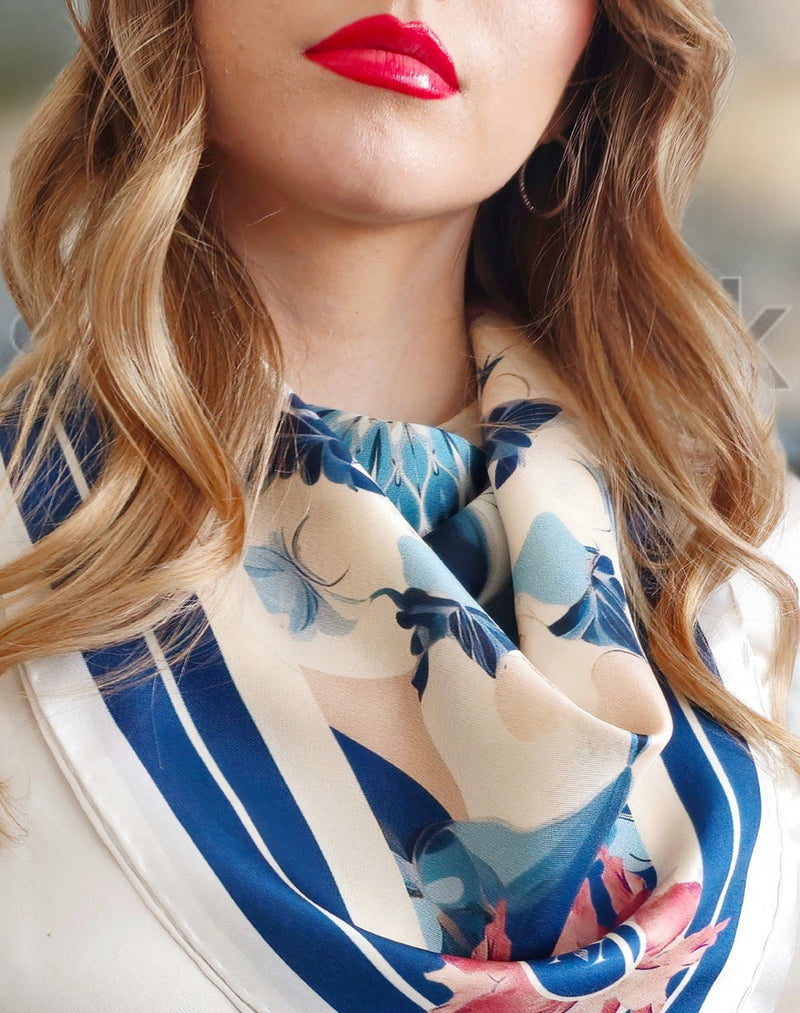 Close of silk scarf on model dressed in white