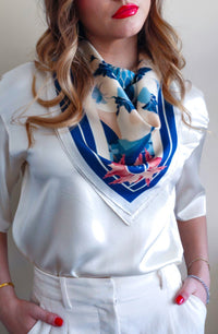 Model in white wearing Mazonkiki blue and white silk scarf front view