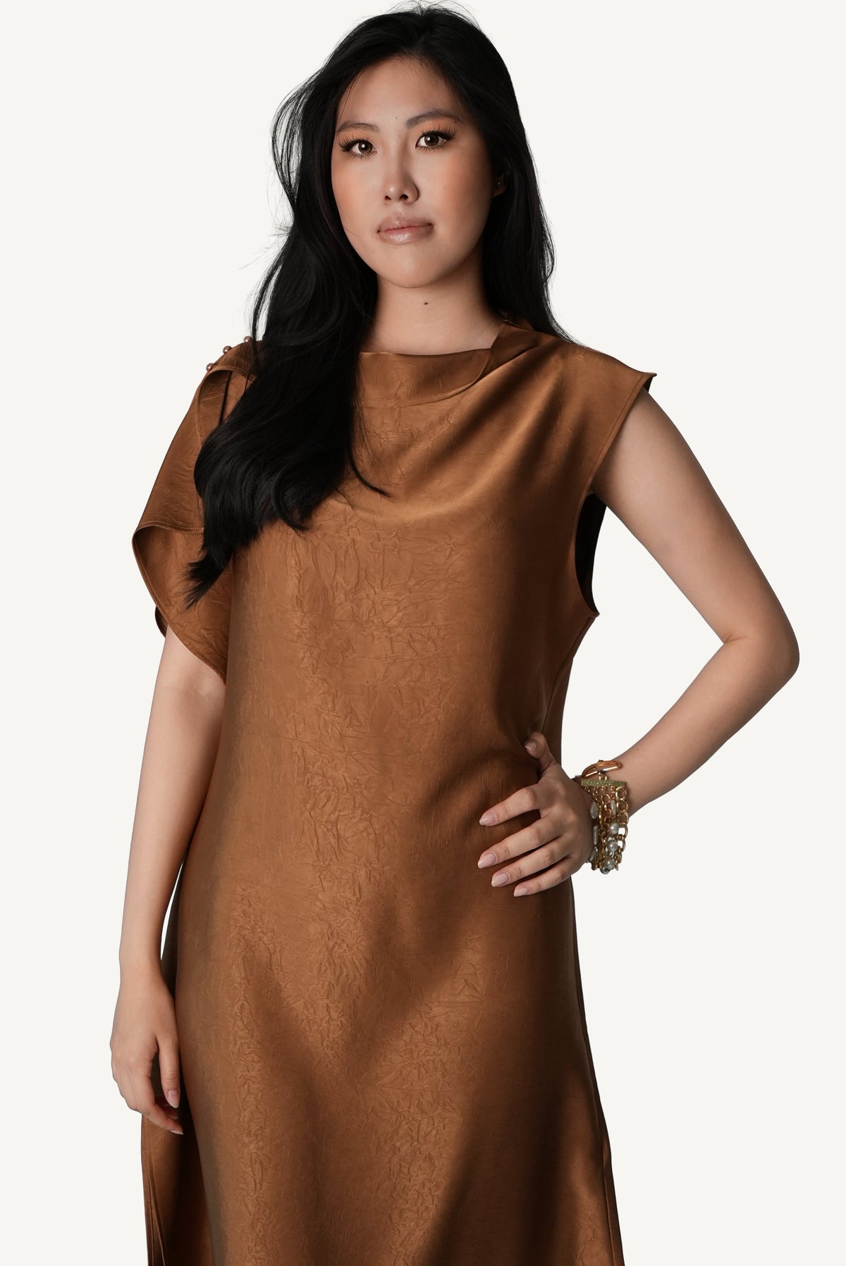 Tactile crinkled tobacco satin surface detail — Mazonkiki Caramel Fold asymmetric drape dress