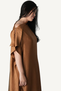 Mazonkiki Caramel Fold asymmetric dress — warm tobacco satin, rose pearl closures, elegant repose