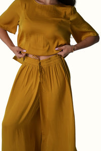 Full-length view of Mazonkiki Mustard Field set — matching cropped tee and wide-leg trousers
