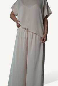 Mazonkiki Pale Repose set in soft ivory — unhurried silhouette with draped cropped tee and wide-leg trouser
