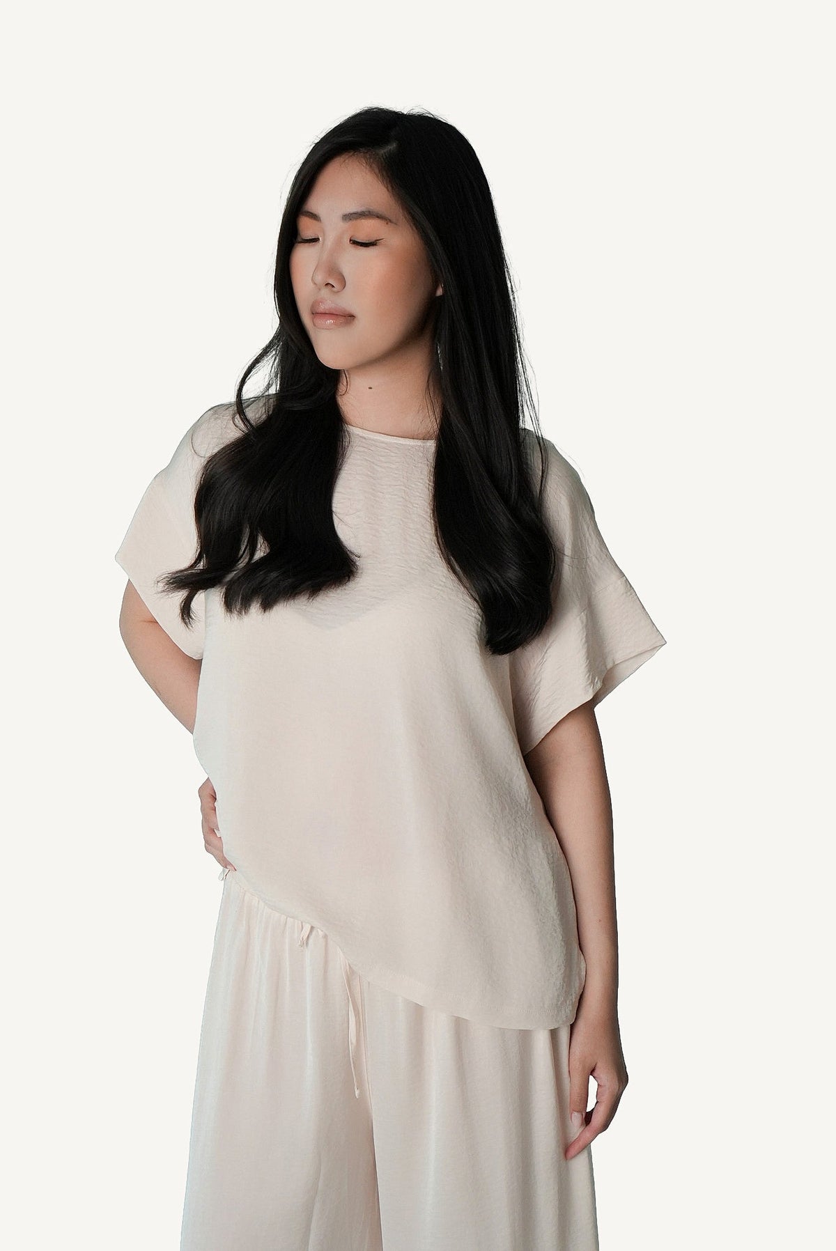 Mazonkiki Pale Repose set detail — soft ivory fabric drape on cropped tee and wide-leg trouser pairing