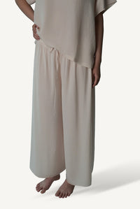 Mazonkiki Pale Repose ivory wide-leg lounge set — cropped tee and floor-pooling trousers in relaxed luxury