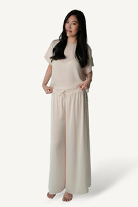 Mazonkiki Pale Repose ivory wide-leg lounge set — relaxed cropped tee and floor-pooling trouser